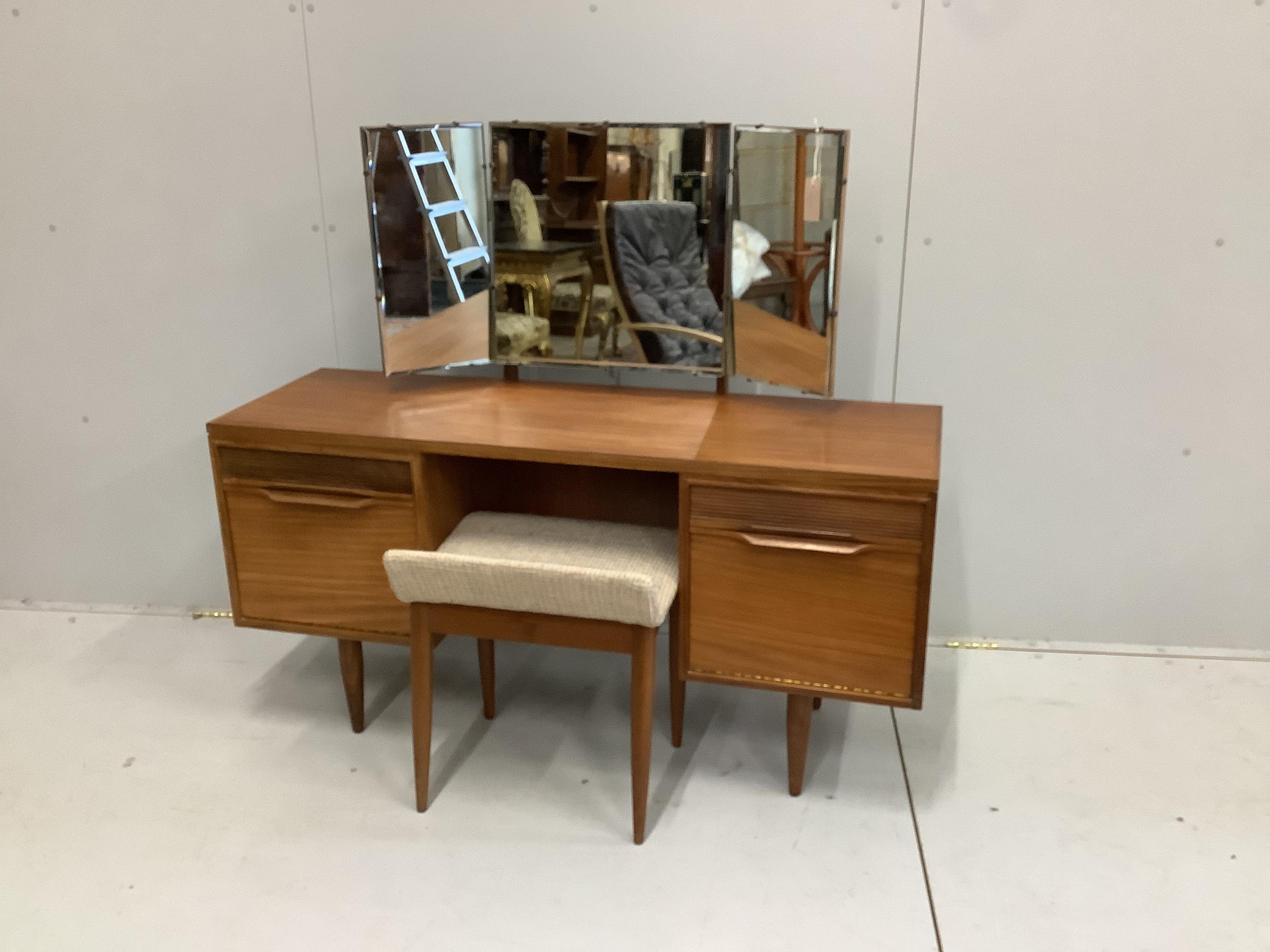 A mid century White & Newton teak dressing table, width 127cm, depth 40cm, height 112cm with triptych mirror and stool